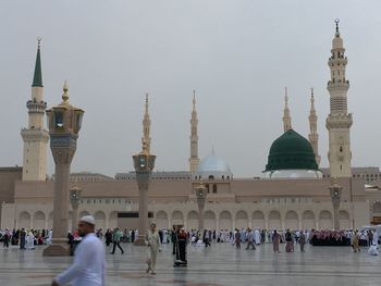 Group of people in front of building against sky