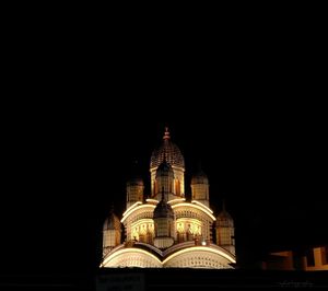 Low angle view of illuminated cathedral against sky at night