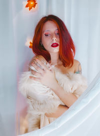 Portrait of young woman in bathtub at home