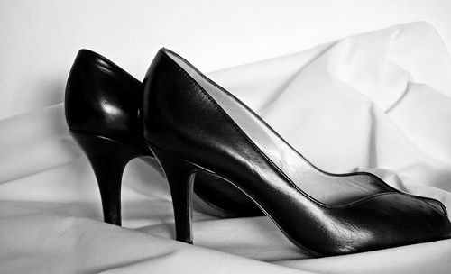 High angle view of black shoes on bed