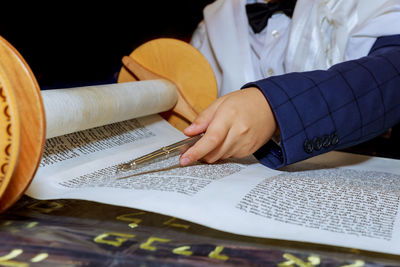 Midsection of person reading book