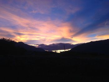 Scenic view of silhouette mountains against sky during sunset