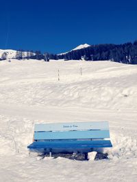 Scenic view of snowcapped mountains against clear blue sky