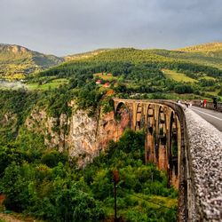 Road by mountain against sky