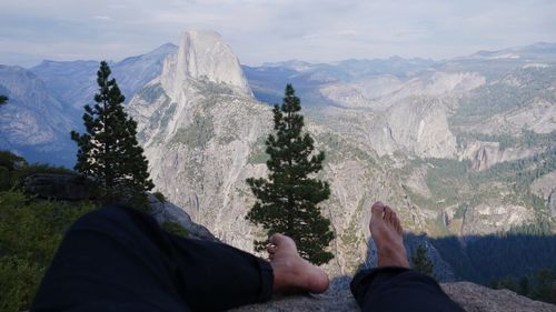 Low section of person relaxing on the top of the mountain