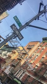 Low angle view of road sign against buildings in city