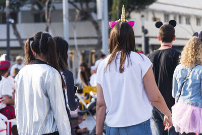 Rear view of people standing on street