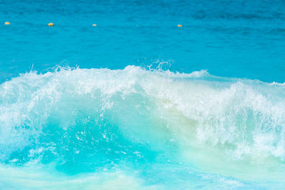 The beautiful sea wave with blue foam and turquoise color.