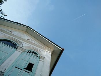 Low angle view of building against clear blue sky