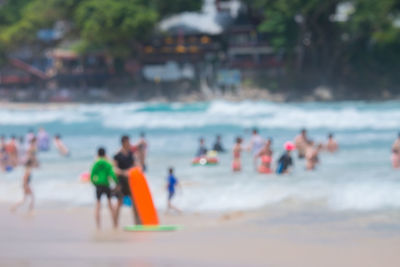 People at beach against sky