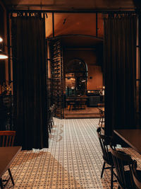 Empty chairs and tables in building