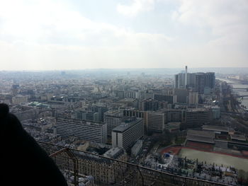 Cityscape against cloudy sky