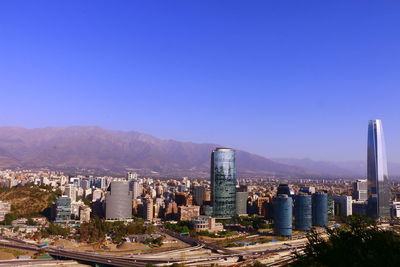 View of cityscape against blue sky