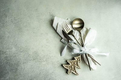 Directly above shot of christmas cookie and eating utensil on table