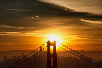 Silhouette of suspension bridge during sunset