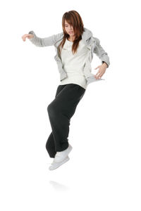 Full length portrait of woman standing against white background