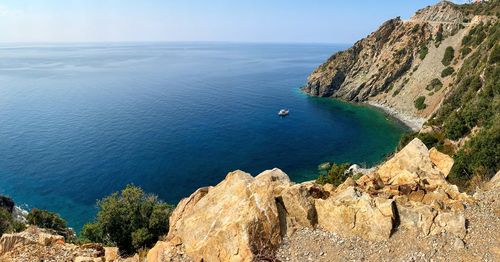 High angle view of rocks by sea against sky