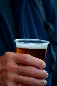 Cropped image of hand holding cup