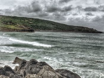 Scenic view of sea against cloudy sky