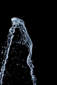 Close-up of water splashing against black background