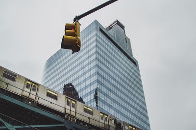 Low angle view of road sign against sky in city