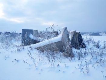 Snow covered land against sky