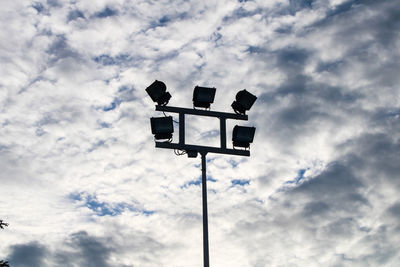 Low angle view of street light against cloudy sky