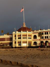 Flag on beach against sky