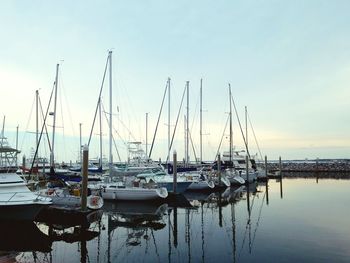 Boats moored on sea against sky