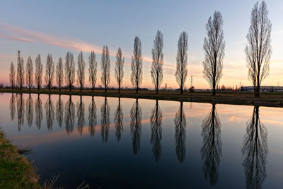 Scenic view of lake against sky at sunset