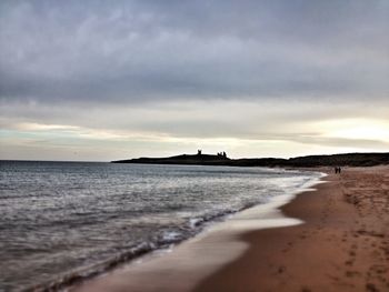 Scenic view of beach against sky during sunset