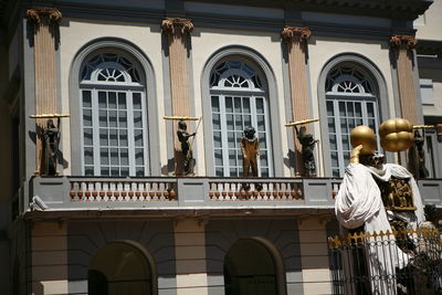 Low angle view of statue against buildings in city