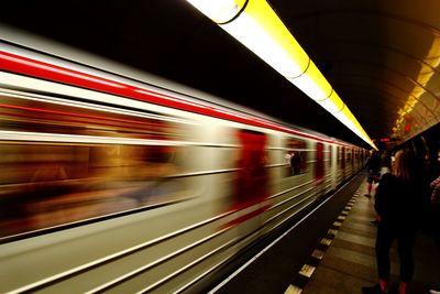 Blurred motion of train at railroad station