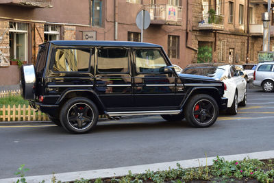 Car parked on street against buildings