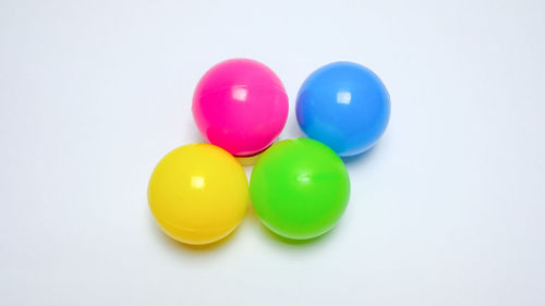 Close-up of multi colored candies against white background