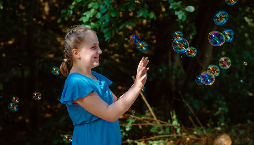 Young woman blowing bubbles