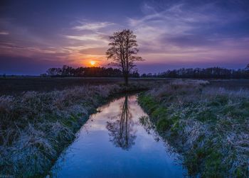 Scenic view of land against sky during sunset