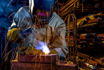 Welder welding in workshop