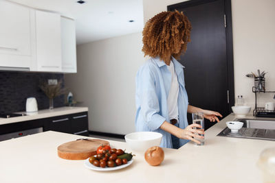 Rear view of woman working at home