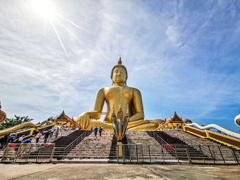 Low angle view of statue against temple against sky