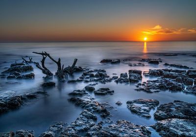 Scenic view of sea against sky during sunset