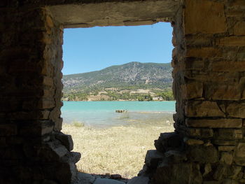 Scenic view of sea against clear sky seen through window