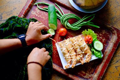 High angle view of person preparing food on cutting board