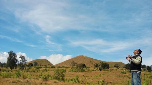 Rear view of woman standing on landscape