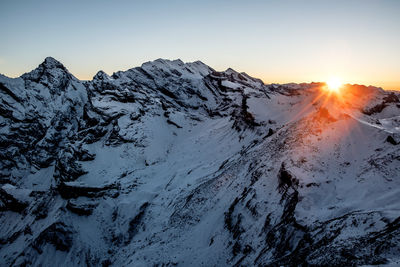 Scenic view of snowcapped mountains against clear sky