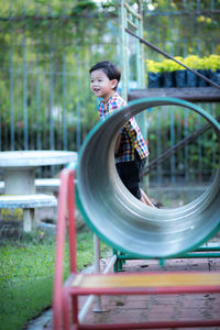 Woman sitting on metal structure