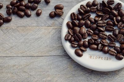 High angle view of roasted coffee bean in plate on table