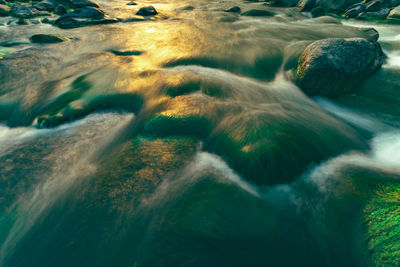 High angle view of water flowing through rocks