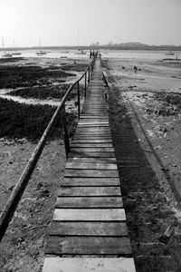 View of pier on beach against sky