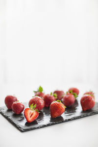 Close-up of strawberries on table against white background